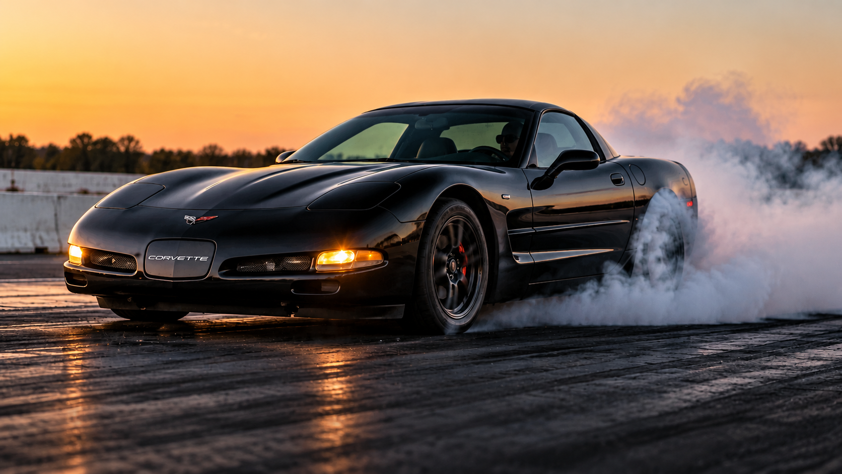 Black C5 Corvette doing a burnout
